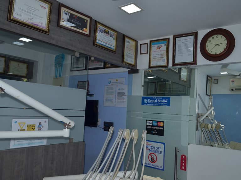 South Mumbai clinic featuring a prominent wall clock along with multiple certifications