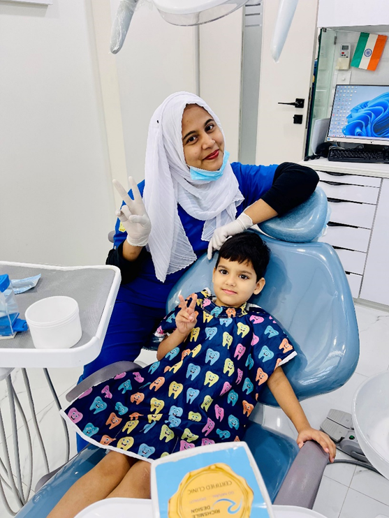 A pediatric dentist with a child seated in a dental chair