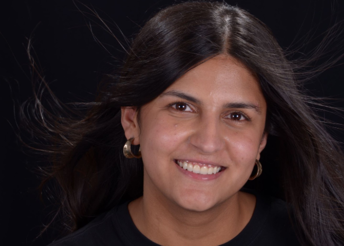 A smiling woman with long black hair